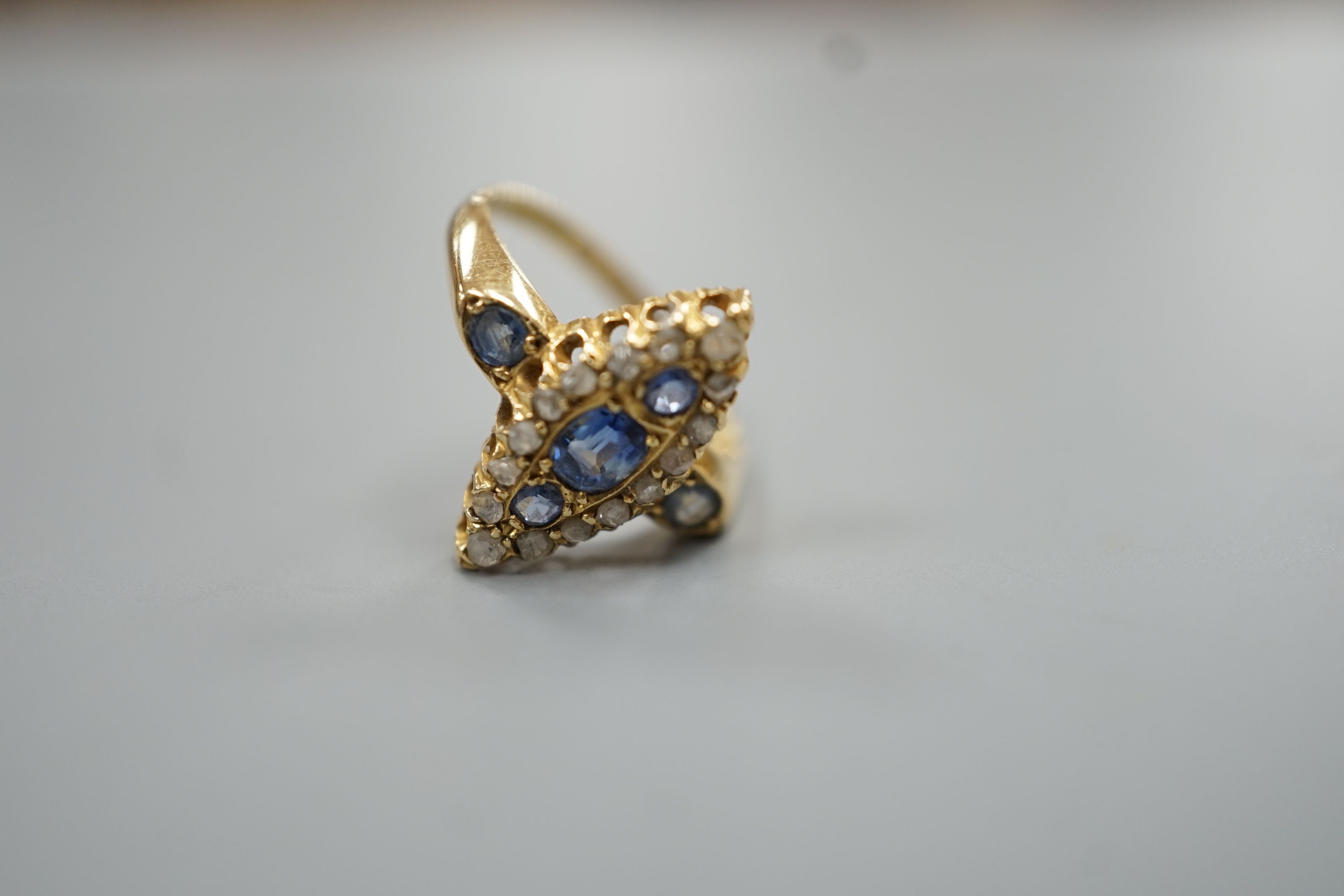 An Edwardian 18ct gold, sapphire and diamond set marquise set cluster ring, size K, gross weight 3.2 grams